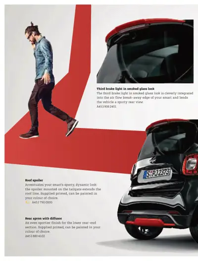 Rear view of black smart car with red accents showing third brake light, roof spoiler, and diffuser details.