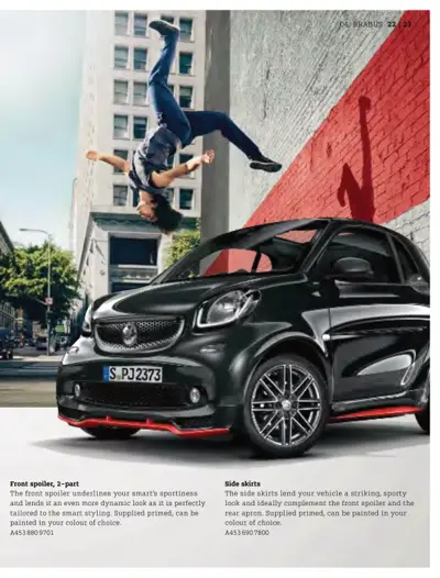 Black Smart car with red accents showing front spoiler and side skirts; acrobat jumping in background.